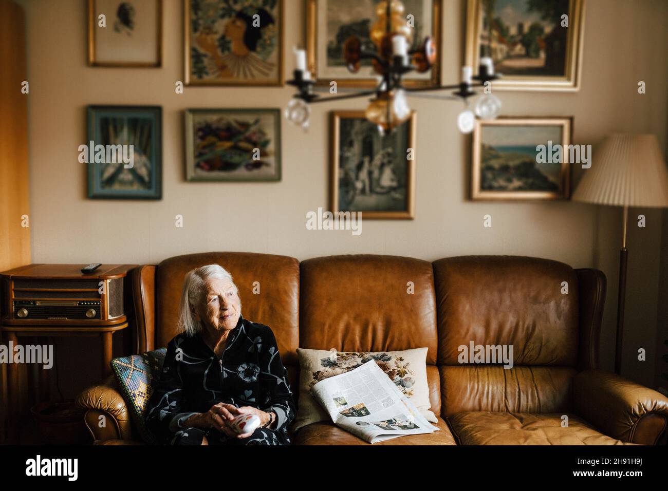 Woman on sofa in living hi-res stock photography and images - Alamy