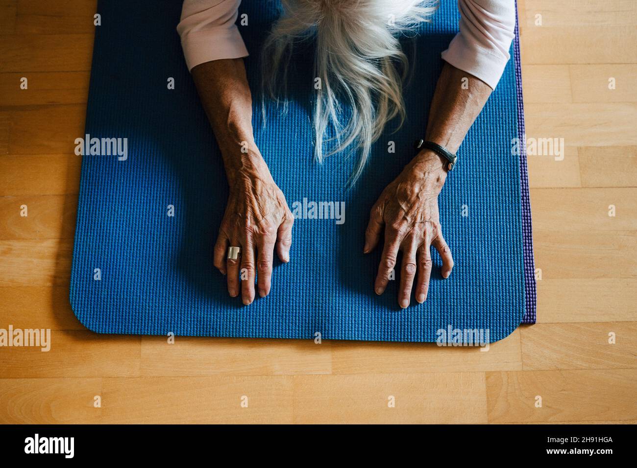High angle view of senior woman exercising on mat at home Stock Photo