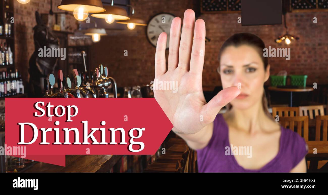 Digital composite image of woman showing hand sign with stop drinking text at bar Stock Photo