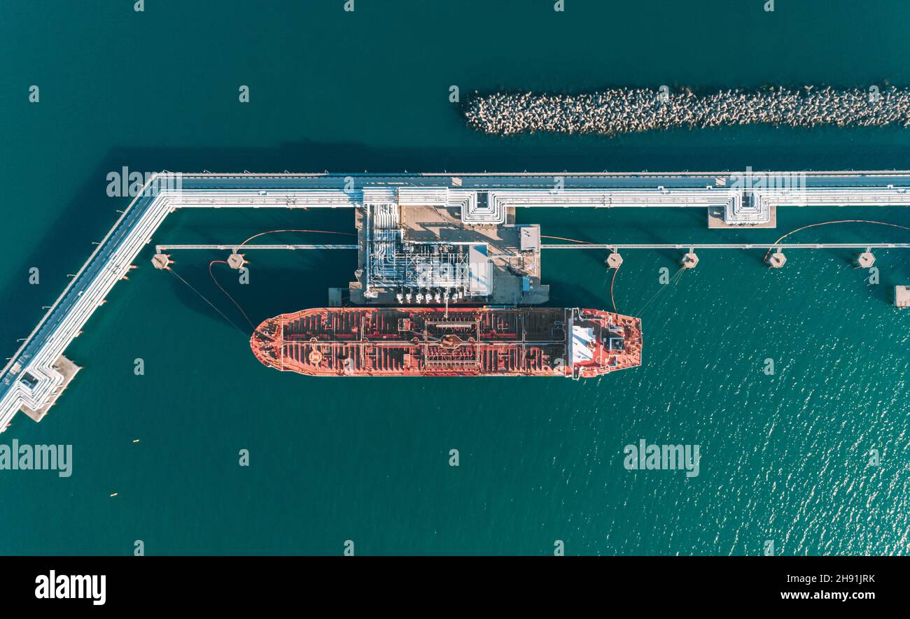 Aerial top down view of an oil tanker ship in process of loading Stock Photo