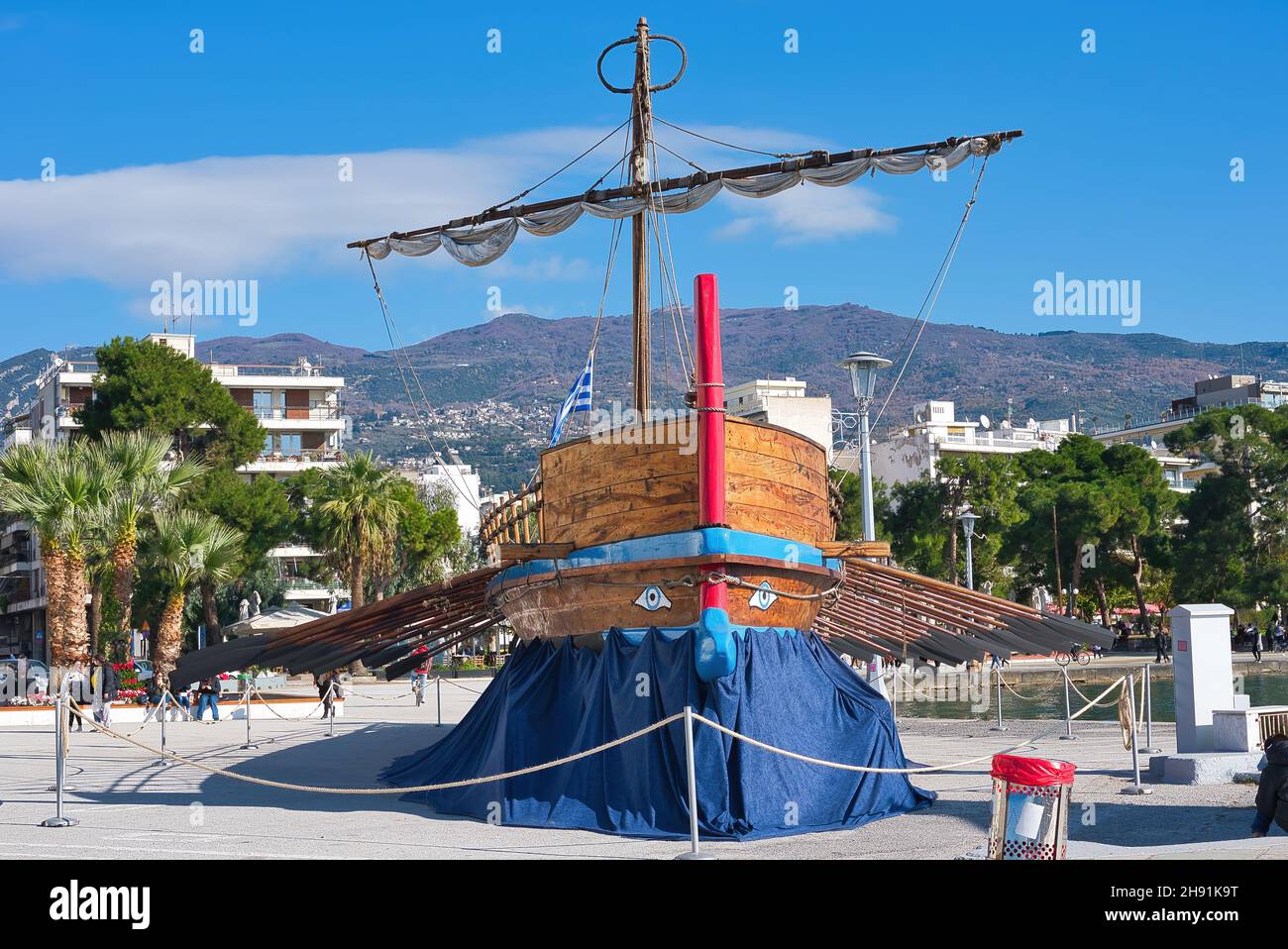 University building and the mythical ship Argo in the port of Volos, two emblems of the city of Volos. Hellas 11-28-2021 Stock Photo