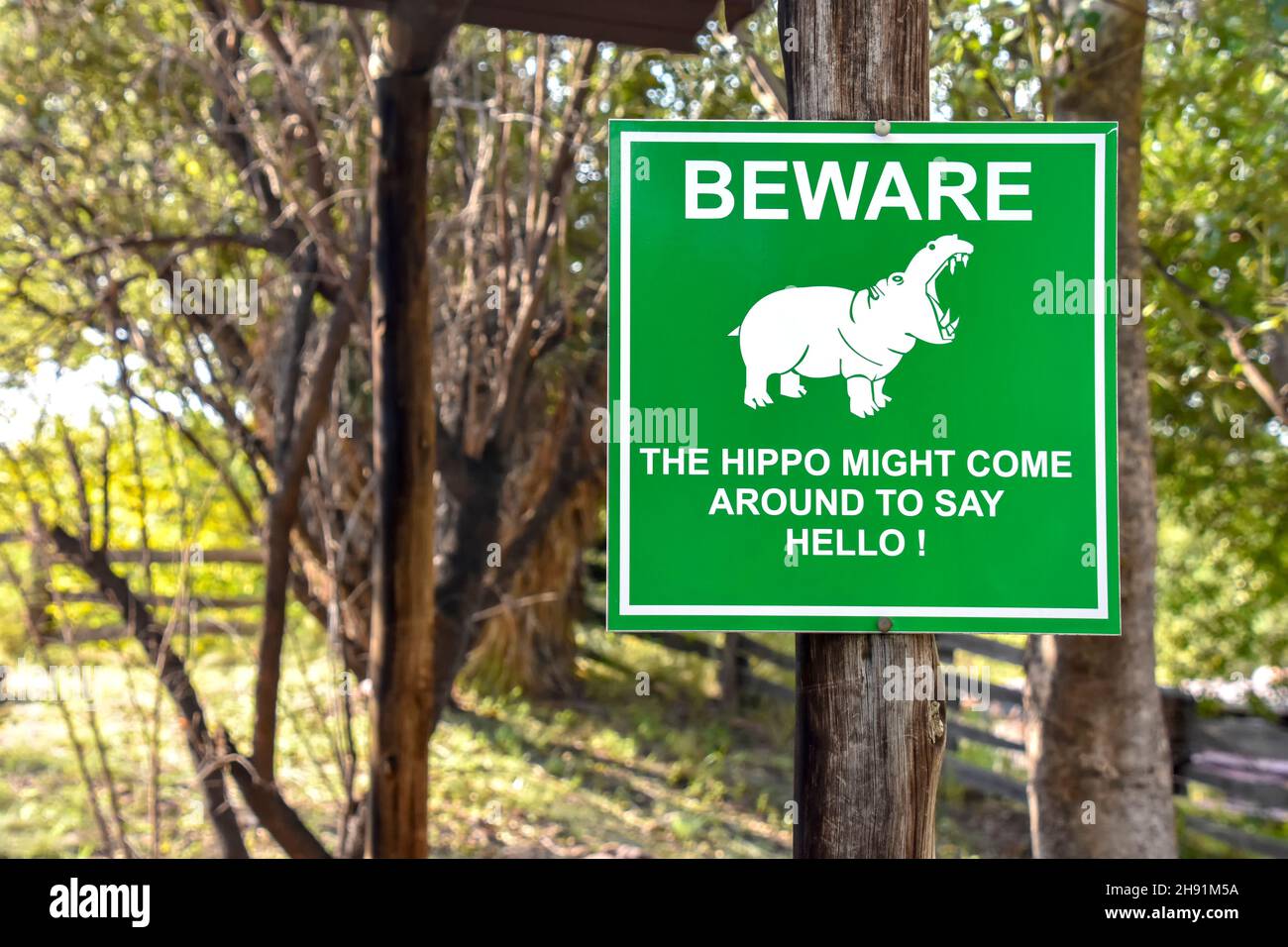 A green sign alerting people saying Be aware the Hippo may come around