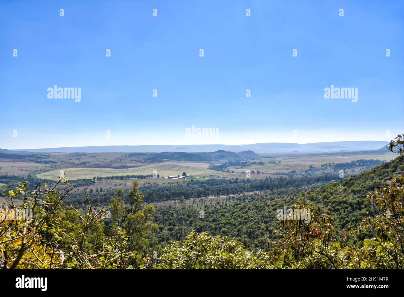 A view of the horizon with its agricultural fields and forests seen from the hills near the Wilge River in Trichardspoort River Valley, Gouwsberg Moun Stock Photo