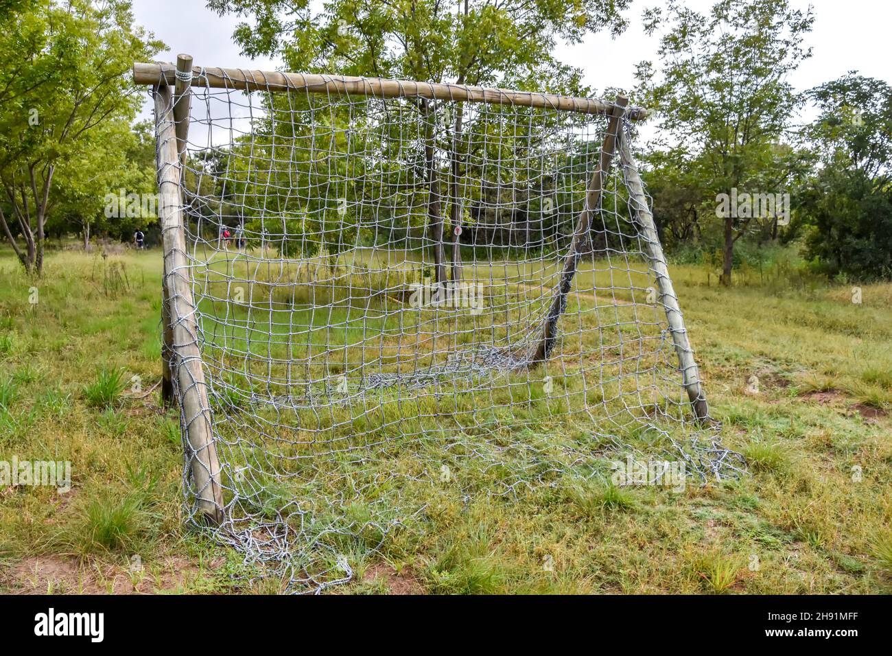A climbing rack made of wooden poles and a net made for an obstacle