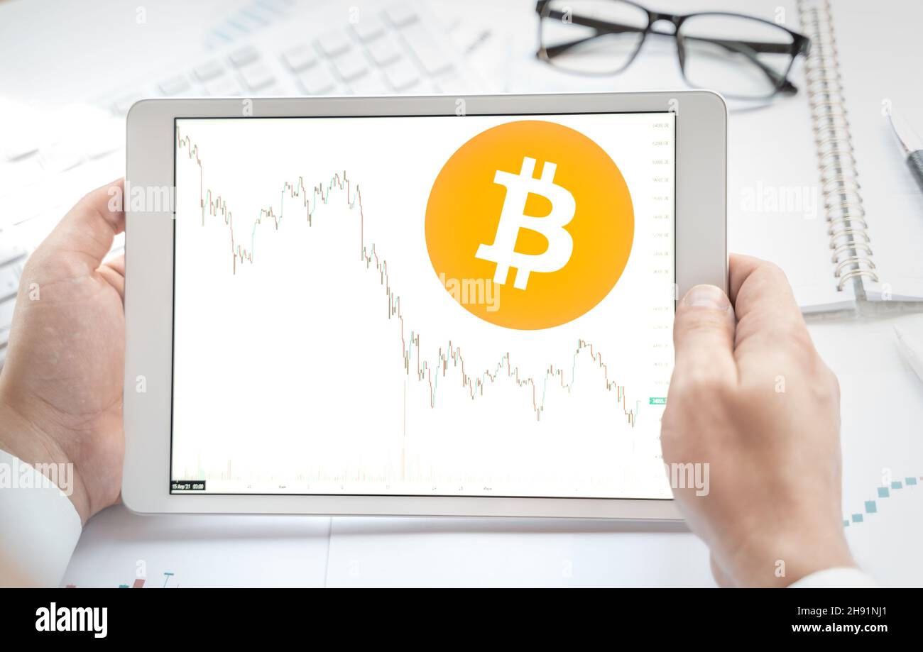 Logo of Bitcoin coin in tablet. Cryptocurrency BTC token. stock price  chart. Trading blockchain platform to buy,sell on decentralized exchange DEX.  Di Stock Photo - Alamy