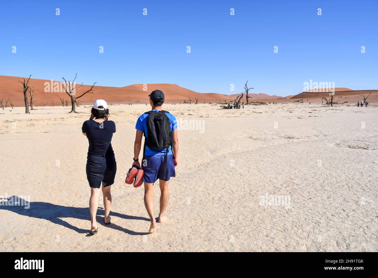 Tourist near the dead or dry lake near the famous sand dunes in the Namib-Naukluft park area in Namibia Southern Africa Stock Photo