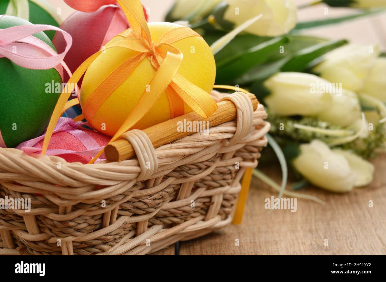 Easter eggs with bows in the basket over floral background Stock Photo ...