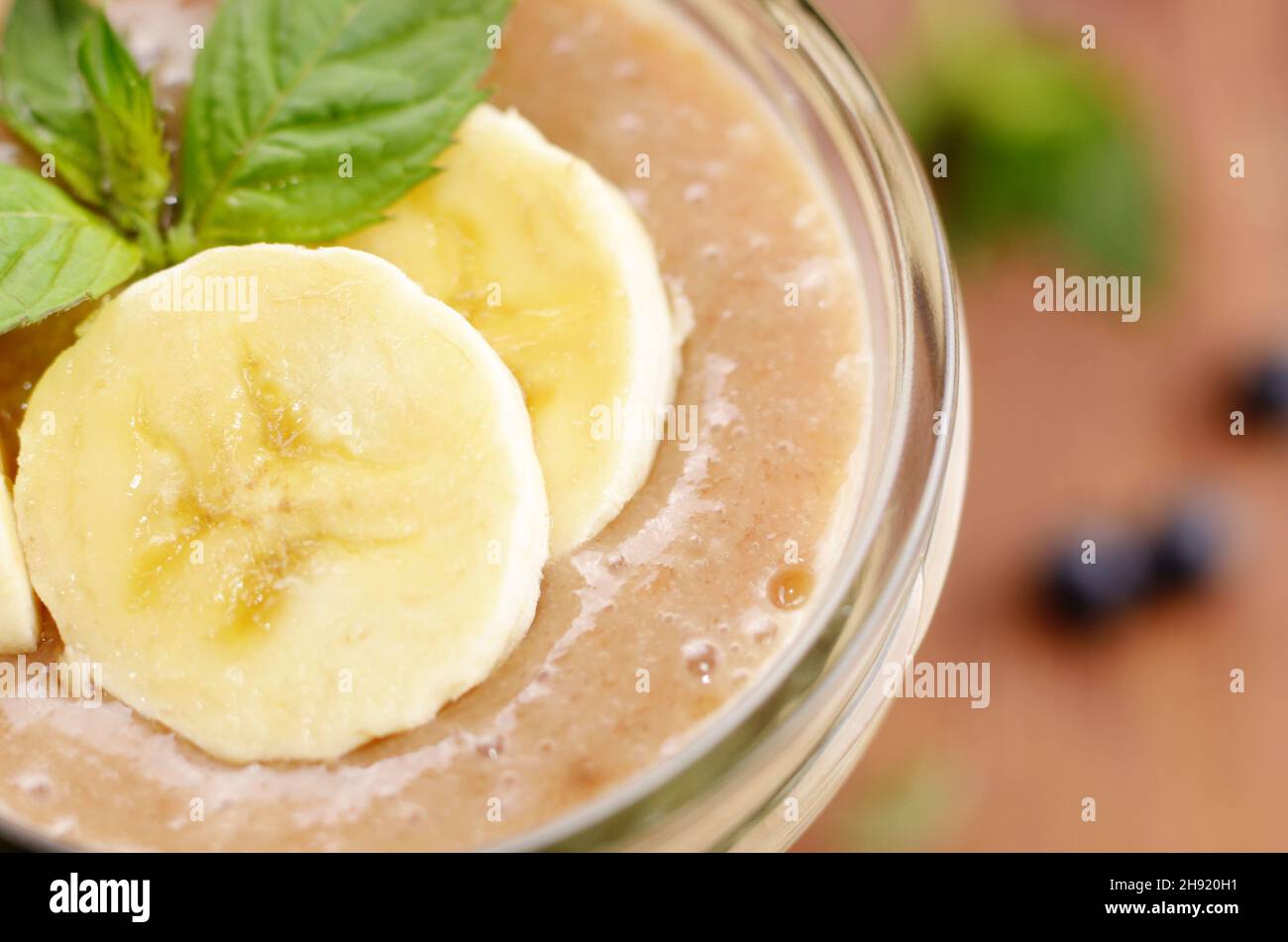 Banana smoothie on wooden table Stock Photo