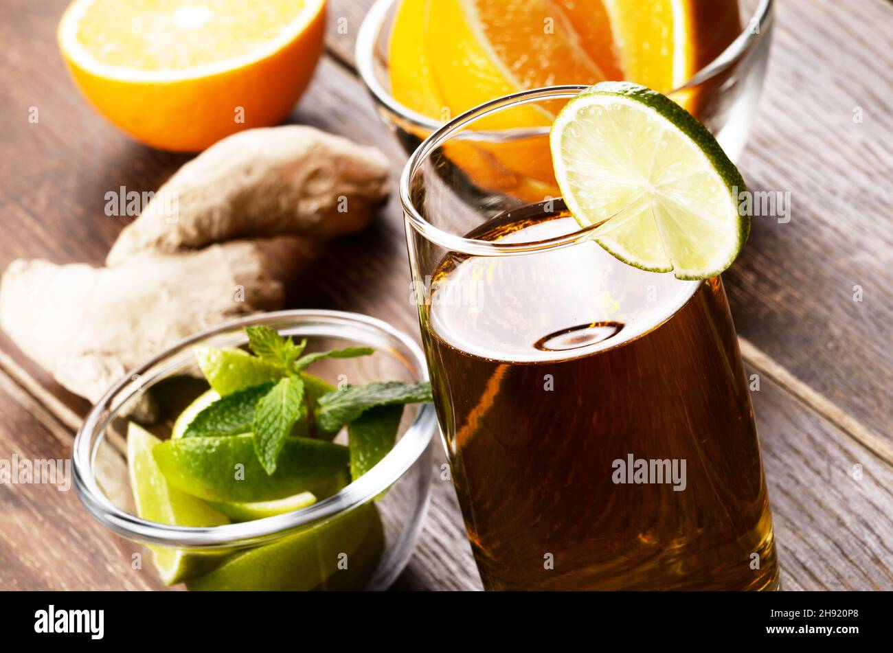 Lime and Mint ginger Fruit Beer with ice on wooden table Stock Photo
