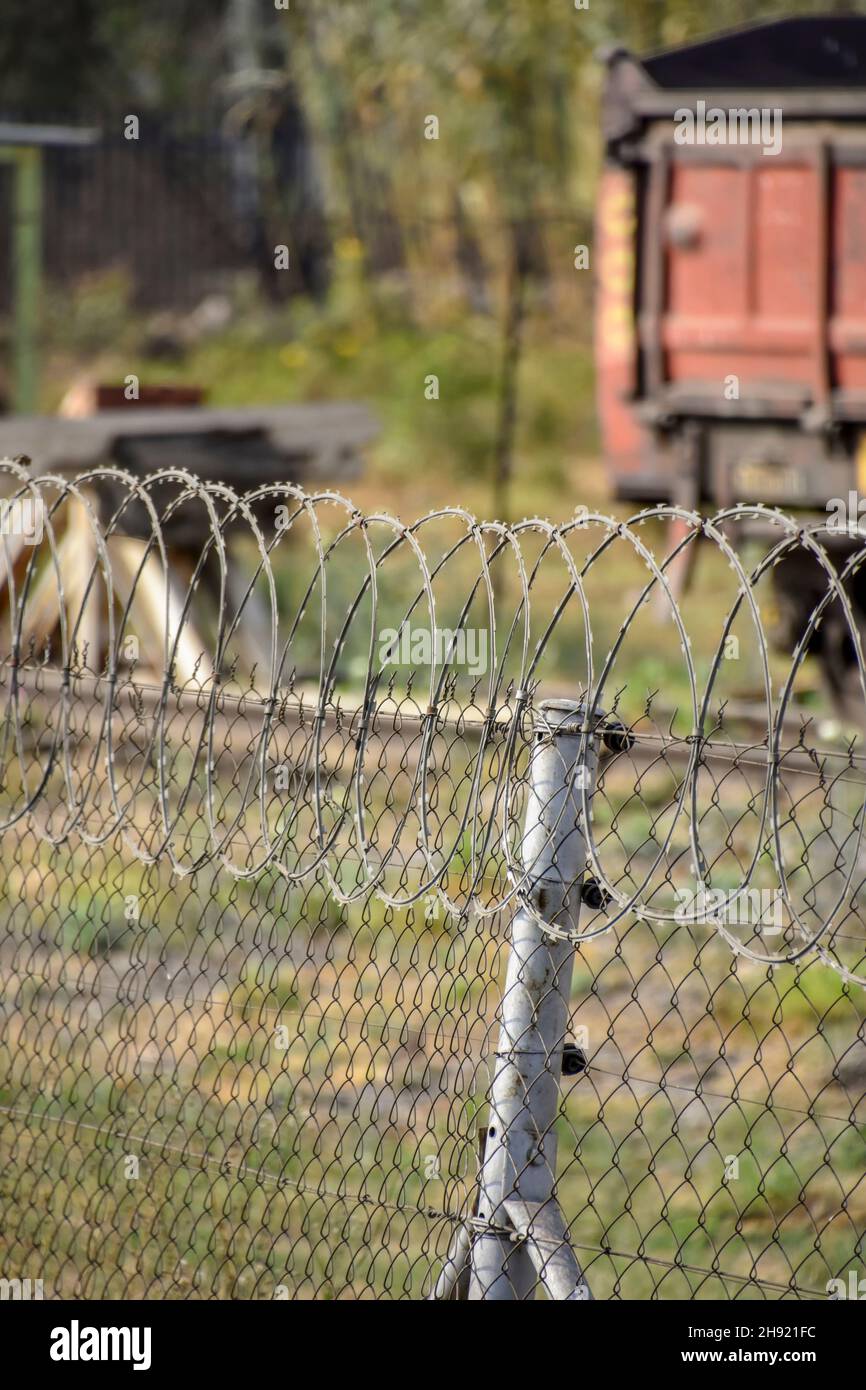 Barbed razor wire in Pretoria South Africa used as steel fencing constructed with sharp edges or points utilized to protect an area from unauthorized Stock Photo