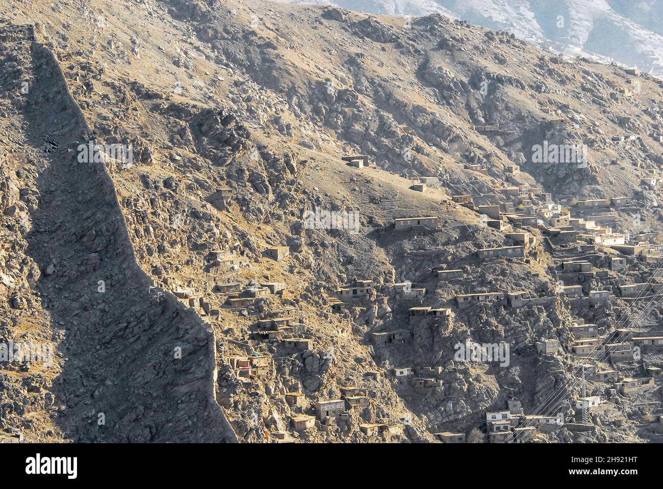 The hillsides of Kabul Afghanistan occupied by informal settlers with a section of the ancient wall Stock Photo