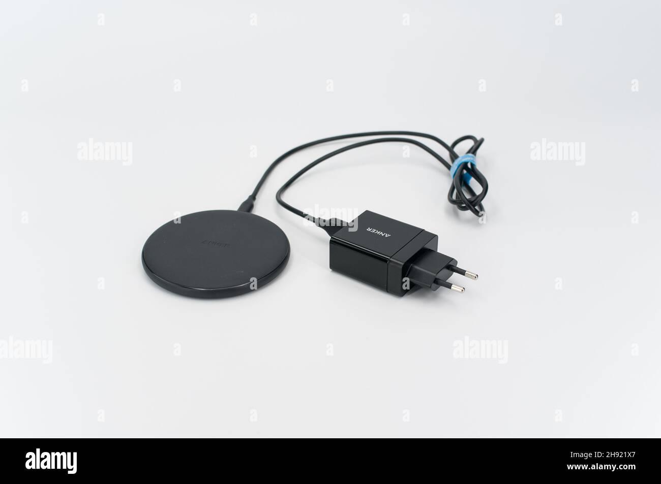wireless smartphone charger on a white tabletop background Stock Photo