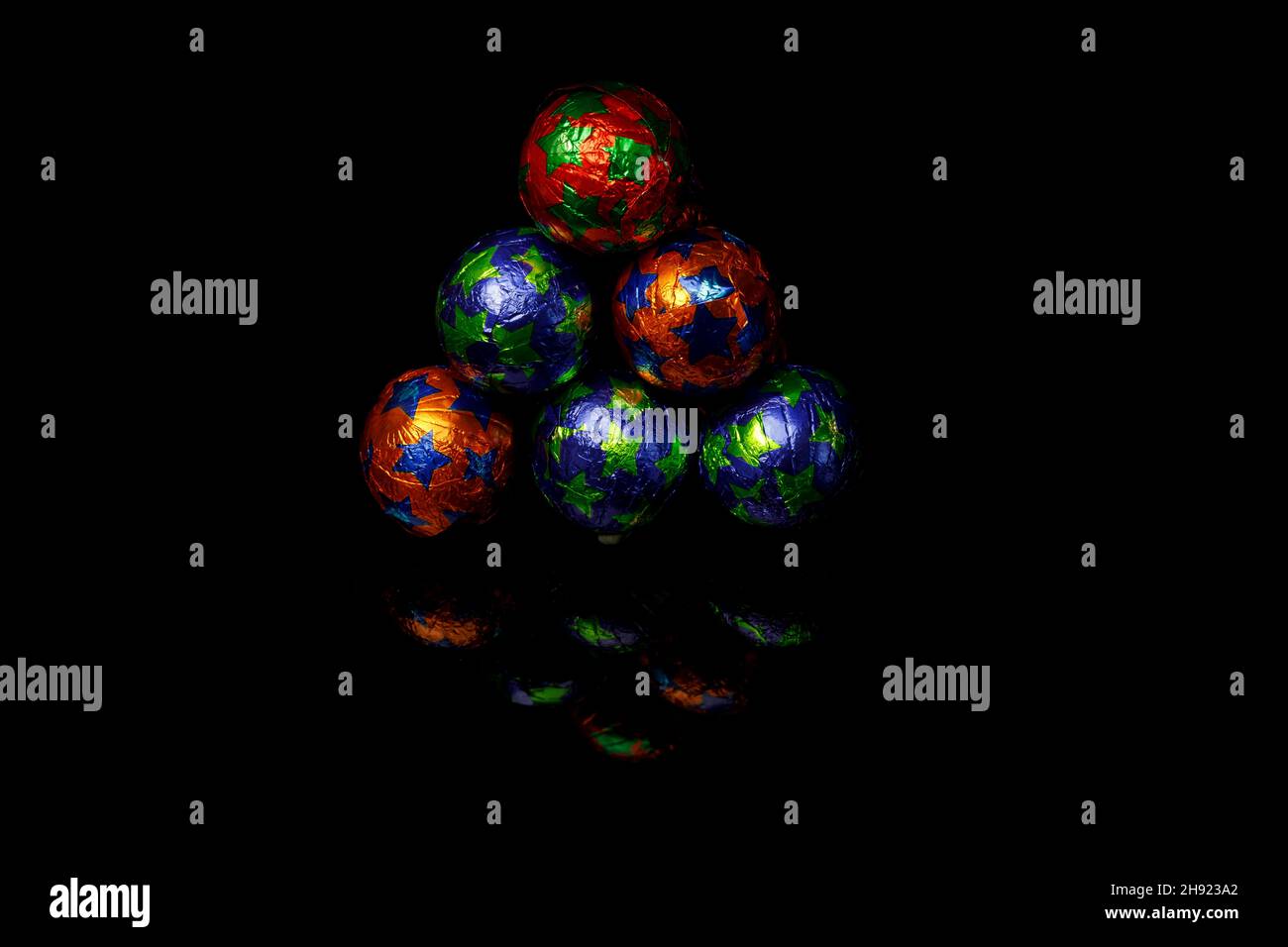 Colorful chocolate balls on black background Stock Photo - Alamy