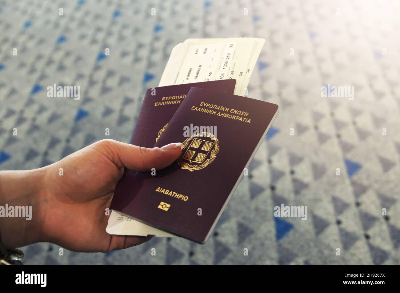 Hand holding passport and airline ticket Stock Photo