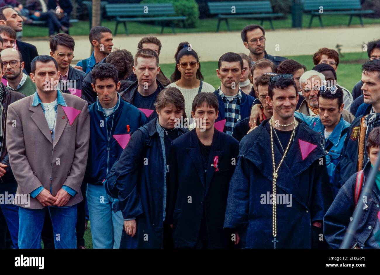 Paris, France, Croxd LGBTQI+ young lesbians and gay men at Memorial Ceremony Homosexuel Deportation, WWII AND pink triangle, Wearing symbolic Pink Triangle, violence against gay men, gay protest vintage Stock Photo