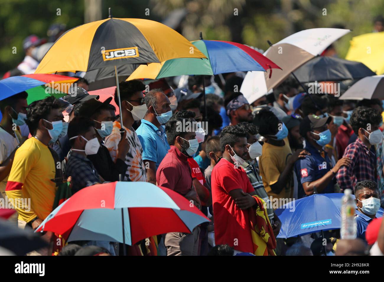 Galle, Sri Lanka. 03rd Dec, 2021. 3rd December 2021; Galle International Stadium, Galle, Sri Lanka; International Test Cricket, Sri Lanka versus West Indies, test 2 of 2, day 5. Sri Lankan fans use umbrellas to keep out of the hot sunshine Credit: Action Plus Sports Images/Alamy Live News Stock Photo