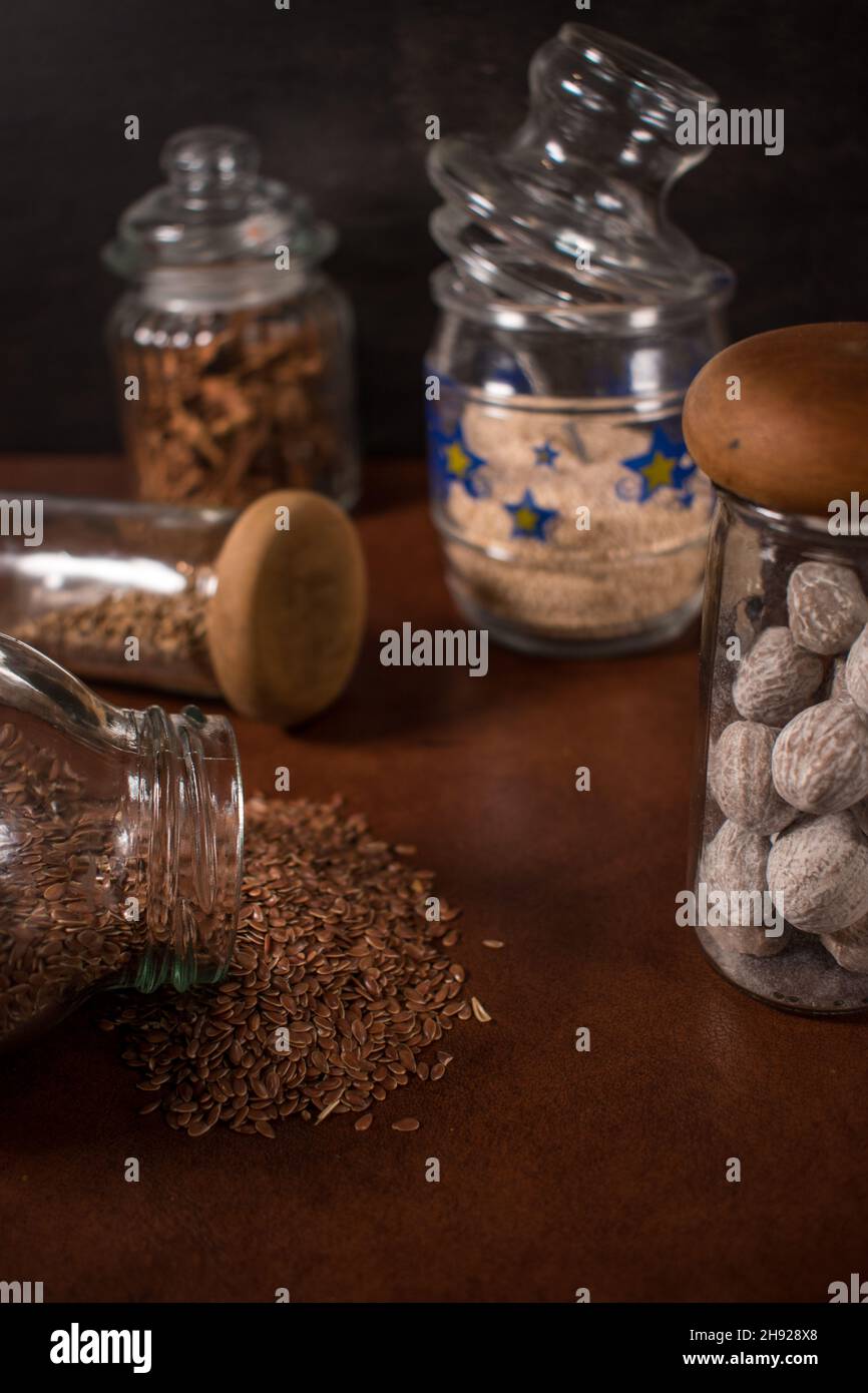 Different spices in some glass bottles on a table Stock Photo