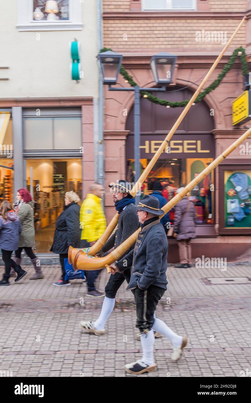 HEIDELBERG, GERMANY - DECEMBER 17, 2017: Two men carrying alpine horns in Heidelberg. Stock Photo