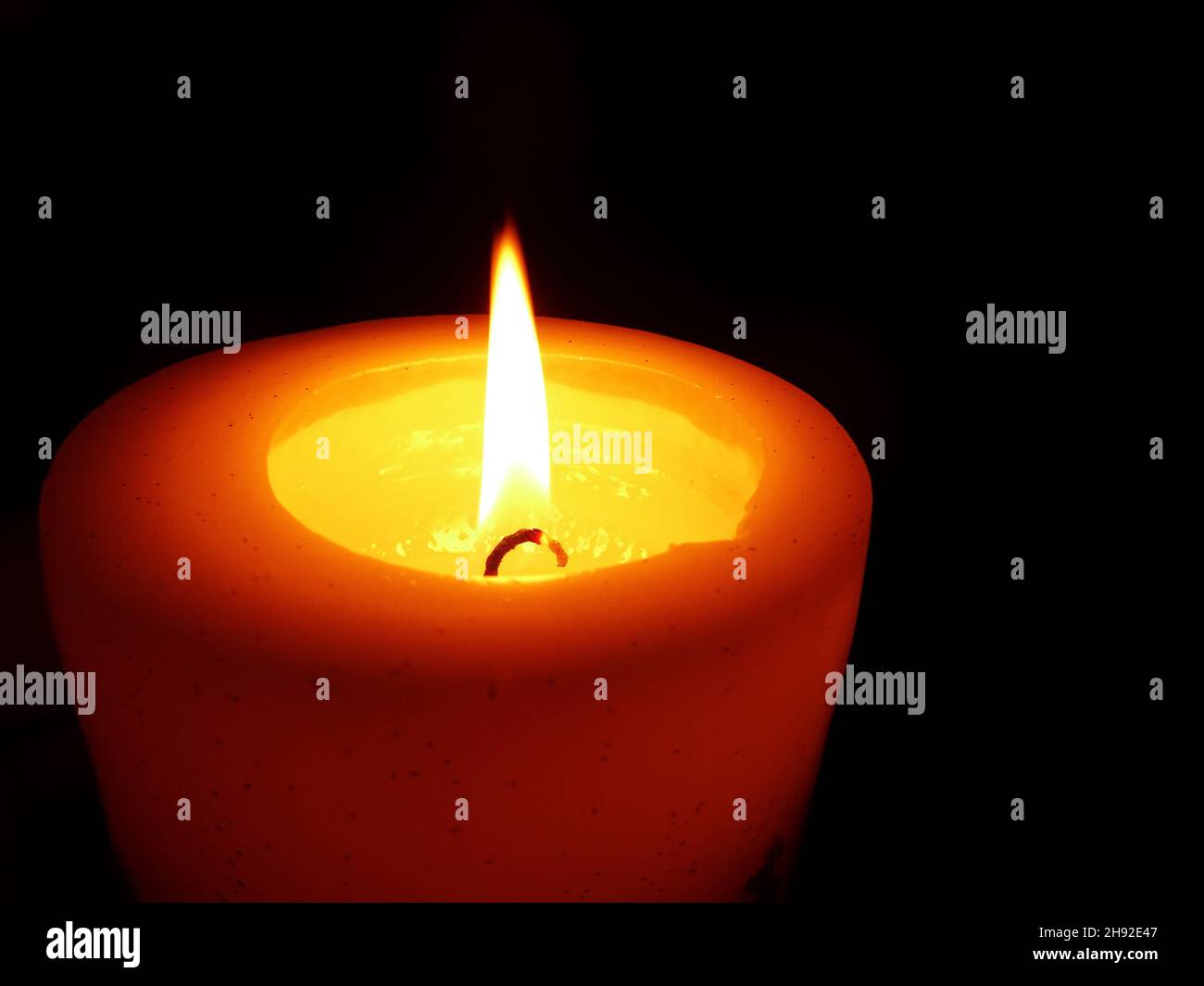Burning candle isolated on black background with copy space Stock Photo