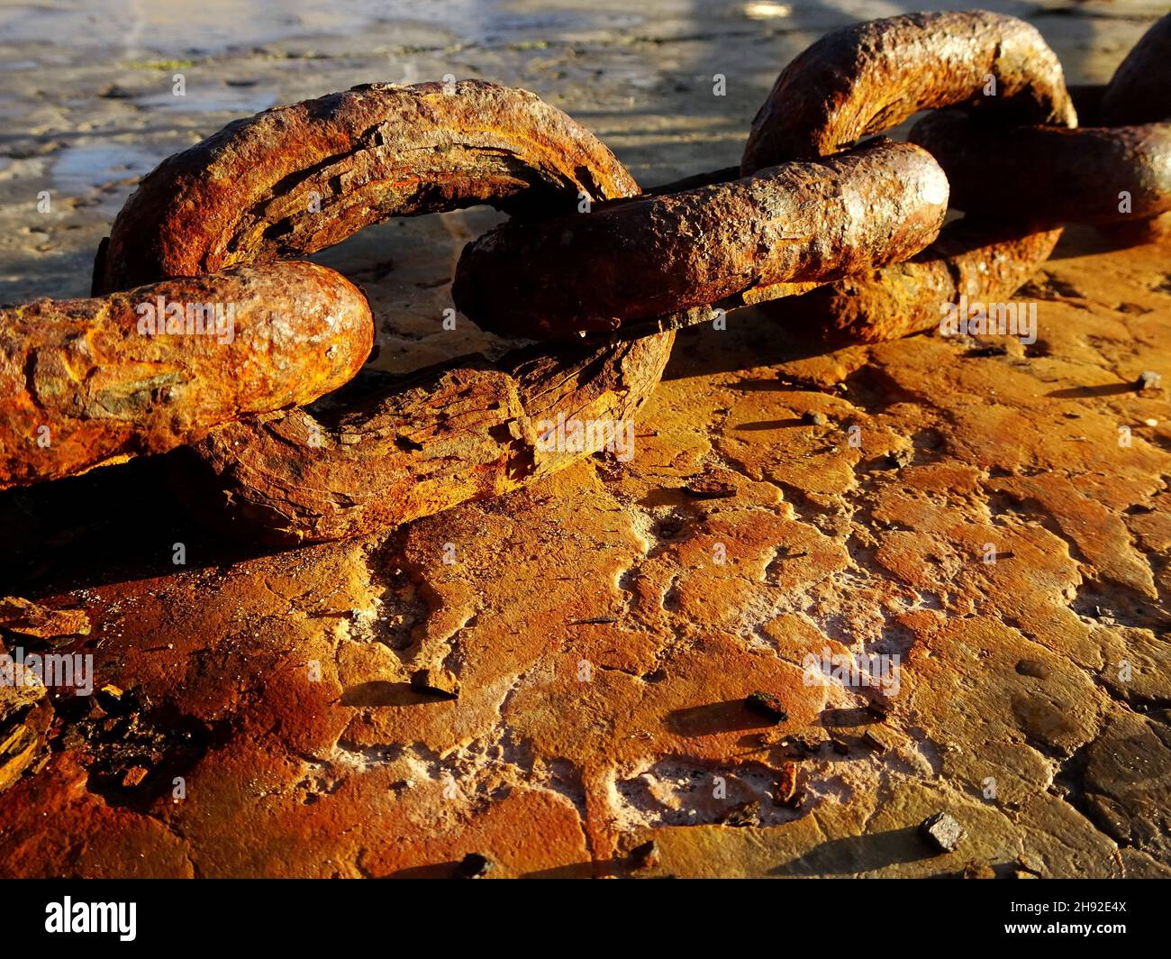 Rusty chain links on concrete Stock Photo