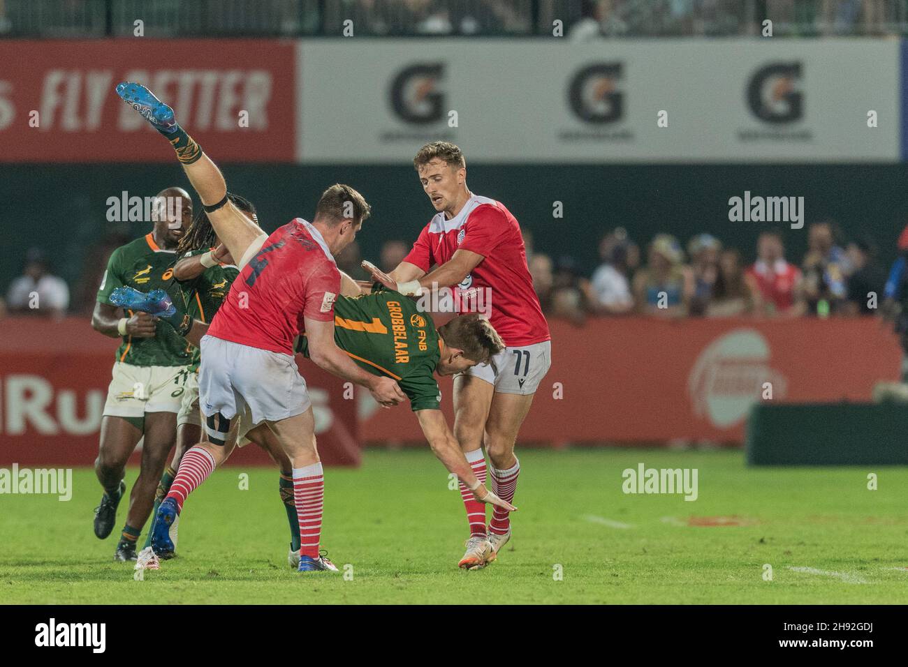 Dubai, UAE. 03rd Dec, 2021. Christie Grobbelaar of South Africa is dump tackled by Tom Williams of Great Britain in the match between Great Britain men and South Africa men during the Emirates Dubai Rugby Sevens day 1 at the Sevens Stadium, Dubai, UAE on 3 December 2021. Photo by Grant Winter. Editorial use only, license required for commercial use. No use in betting, games or a single club/league/player publications. Credit: UK Sports Pics Ltd/Alamy Live News Credit: UK Sports Pics Ltd/Alamy Live News Stock Photo