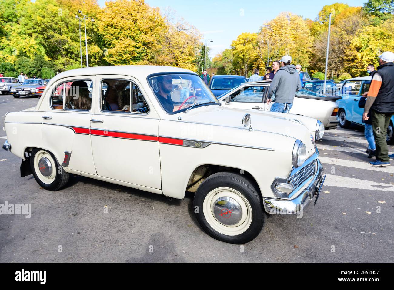 Bucharest, Romania, 24 October 2021: One vivid white Moskvitch 403 Russian vintage car in traffic in a street in the city center, in a sunny autumn da Stock Photo