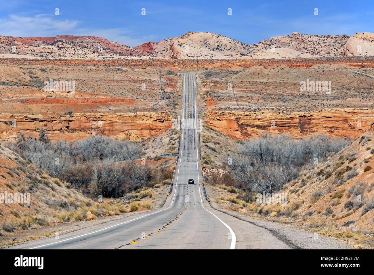Lonely car driving on the U.S. Route 191 / US 191 highway through Utah's Red Rock Country to Bluff, San Juan County, United States, USA Stock Photo