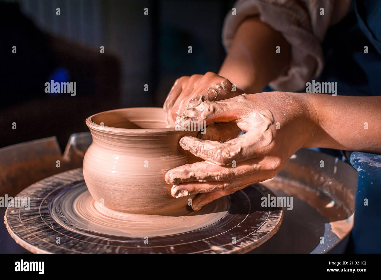 Young female potter working on a potter's wheel Stock Photo Alamy