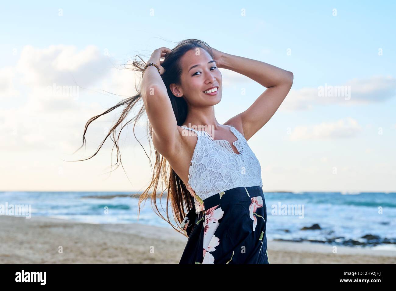 Beauty portrait of a beautiful young woman with long hair on the sea beach Stock Photo