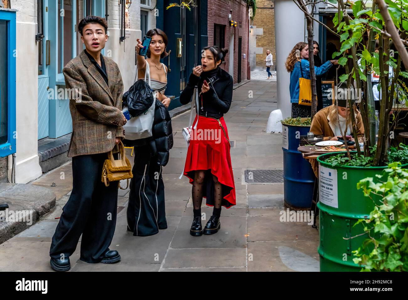 A Group Of Young Asian Visitors In Neal’s Yard, Covent Garden, London, UK. Stock Photo
