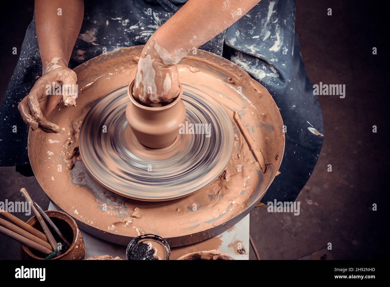 production process of pottery. Forming a clay teapot on a potter's