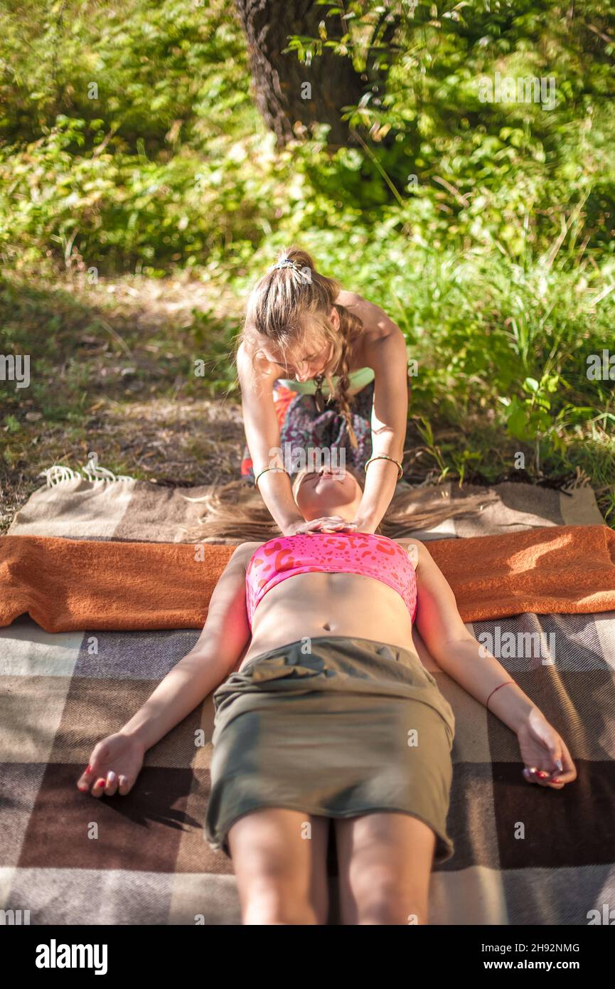 Master massage therapist demonstrates refreshing massaging methods in nature. Stock Photo