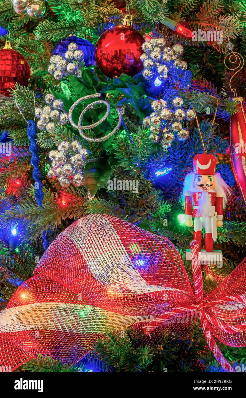 A wooden toy soldier hangs on a patriotic Christmas tree in red, white , and blue. Stock Photo