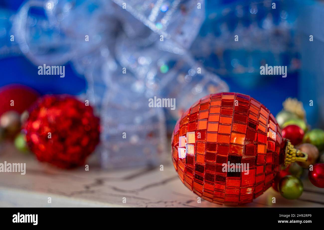 Red, white and blue Christmas ornaments and packages sit together on a fireplace mantel. Stock Photo