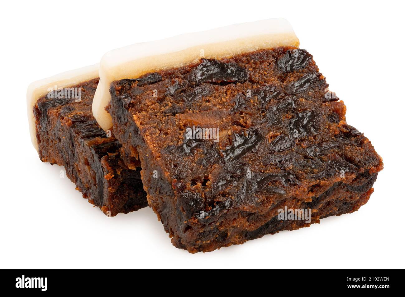 Two slices of iced fruit cake isolated on white. Stock Photo