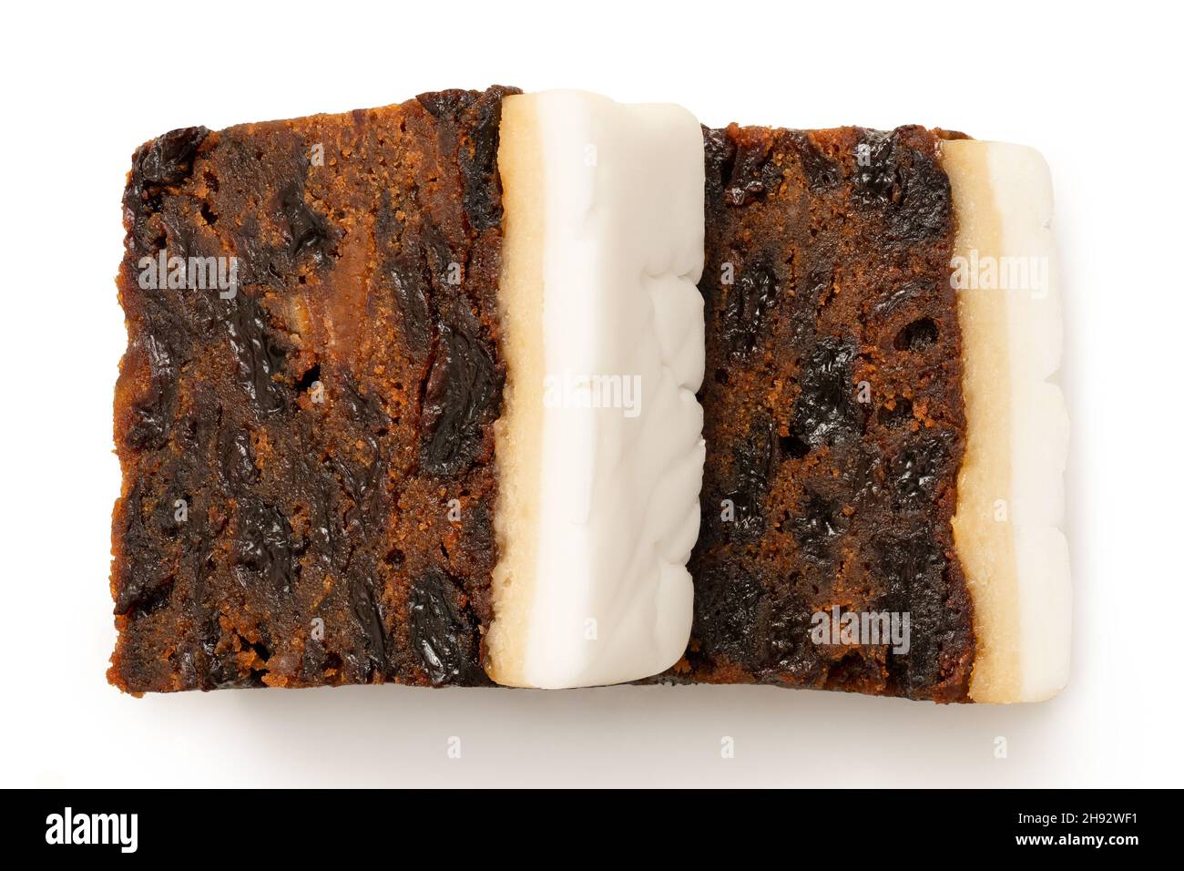 Two slices of iced fruit cake isolated on white. Top view. Stock Photo