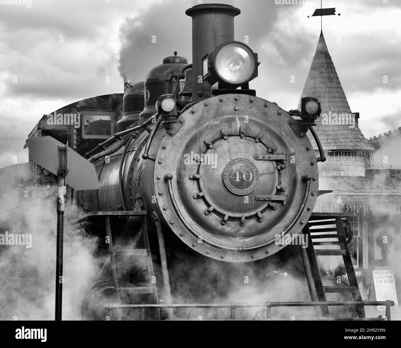NEW HOPE, UNITED STATES - Sep 01, 2017: A grayscale shot of an old Locomotive and steam coming out of it. Stock Photo