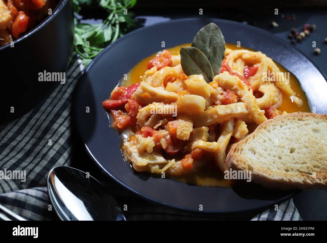 Italian food. Dish of typical beef tripe with tomato sauce with bread