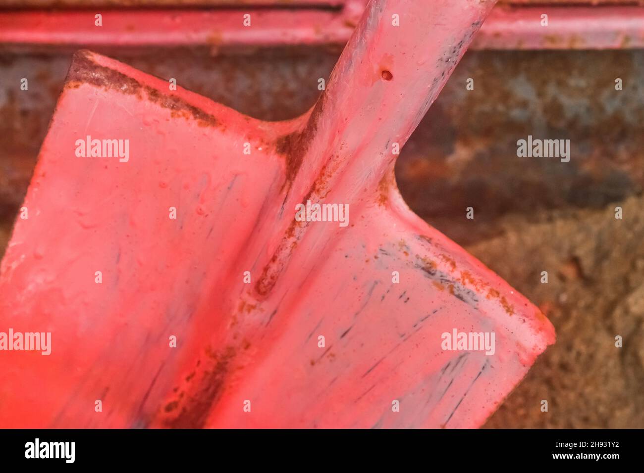 Old red fire shovel equipment and tools to help safely extinguish fire. Stock Photo