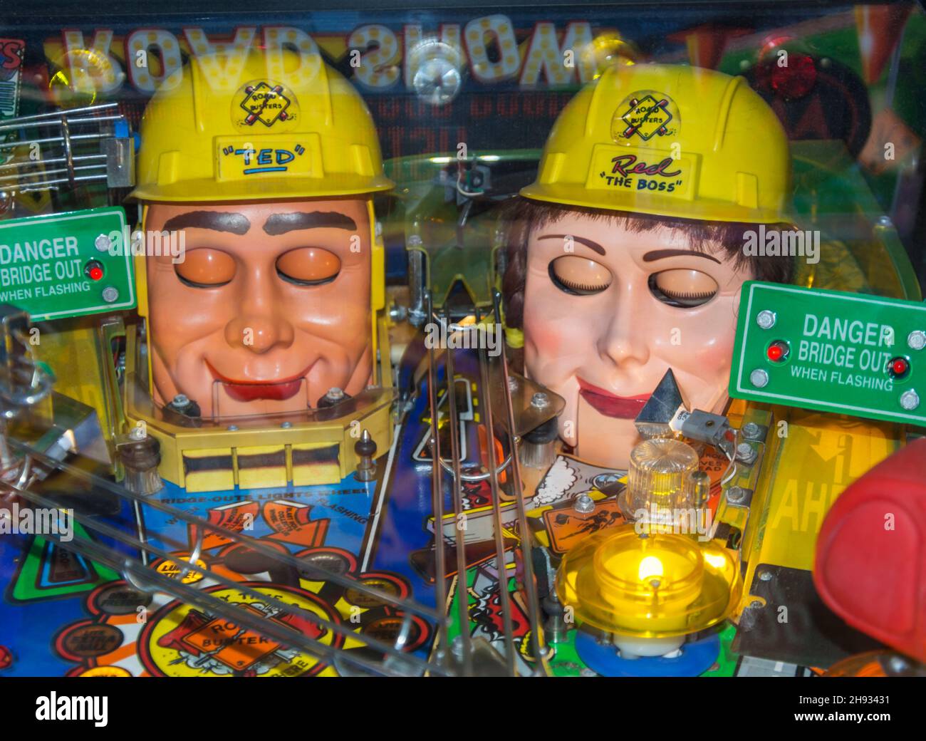 A pinball machine with creepy doll-type heads Stock Photo