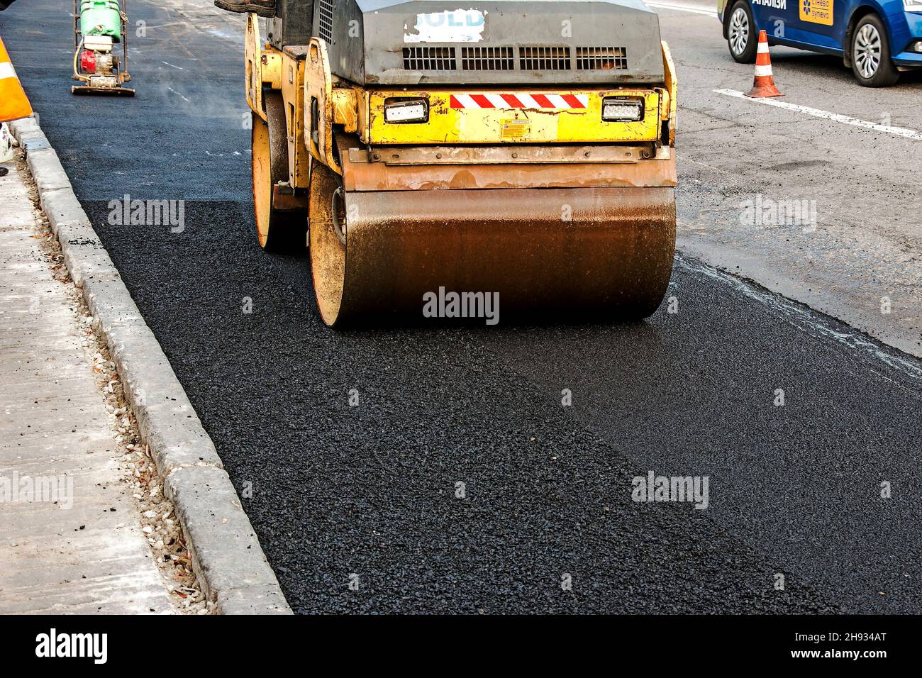 Compact steamroller flatten out the asphalt. Heavy Vibration roller at