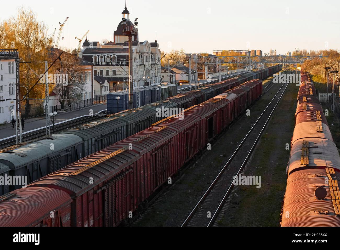 Lutsk, Ukraine - May 26,2021: Roofs of cargo train with shipping container in depot. Freight train carriages at railway station. Classification or Stock Photo