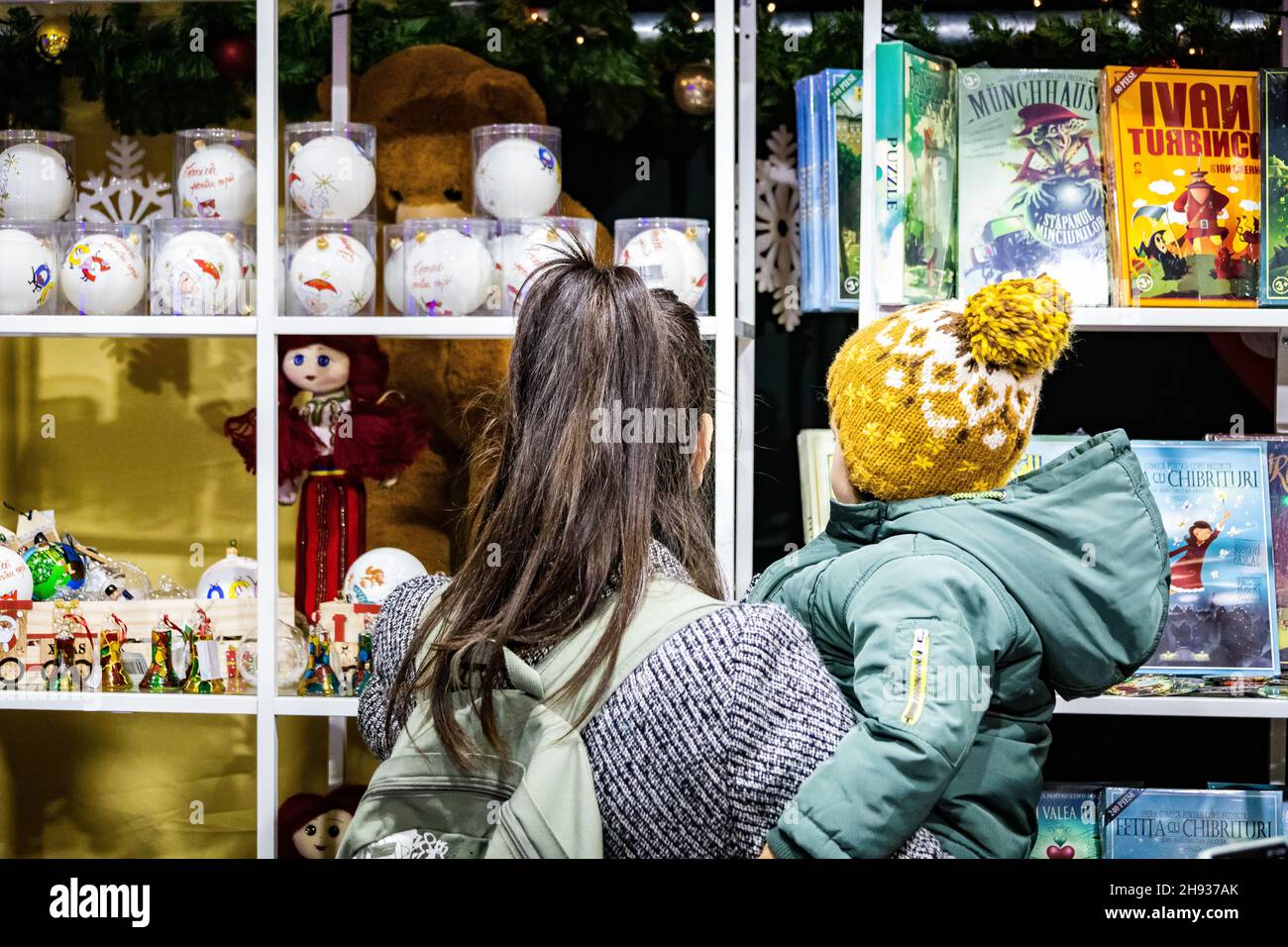 Bucharest, Romania. 3rd Dec. 2021. Mother and her child looking for presents Stock Photo