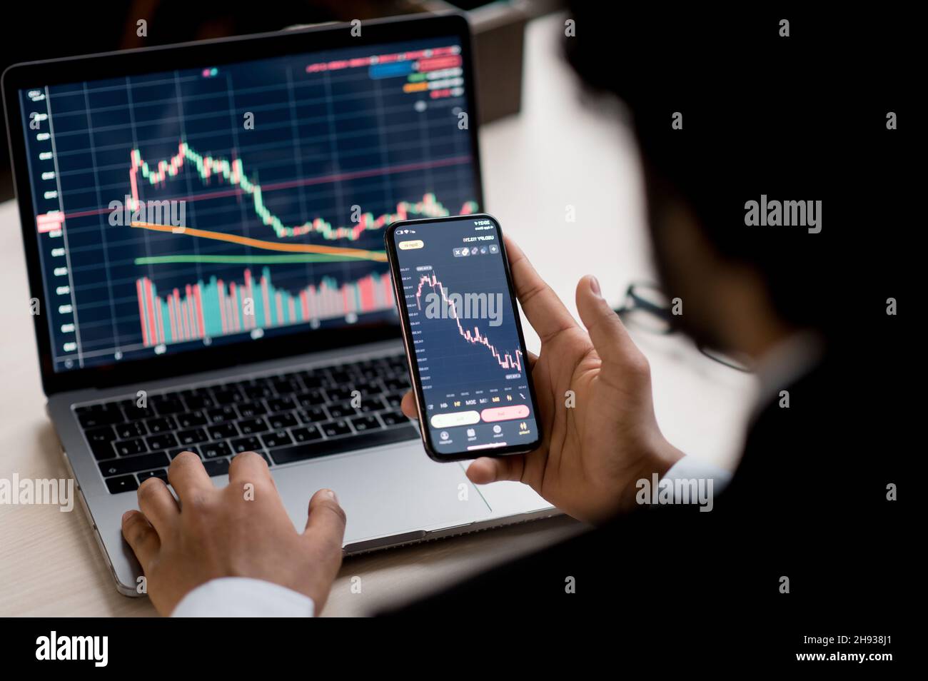 Close-up of laptop and smart phone screen with diagrams. Crypto, stock  trader investor broker using smartphone and laptop for cryptocurrency  financial market analysis, buying or selling cryptocurrency Stock Photo -  Alamy