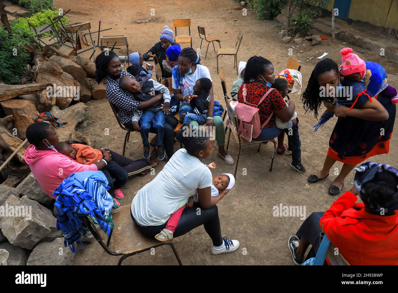 July 23, 2021, Nairobi, Kenya: Women seen waiting with their kids during the event.Cerebral palsy is an abnormal development of brain tissue that affects children making them unable to control their muscles, this usually occurs before or mostly after a child is born. A group of Medical experts and massage therapists from The Action Foundation (T.A.F) came together to help and supports different families with young kids suffering from Cerebral Palsy. Since most families are not able to afford the high costs of medical services and therapies for their babies with disabilities, The Action Founda Stock Photo