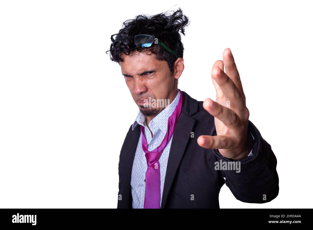 Very angry businessman scolding and about to yell. Young businessman accusing and firing someone while looking at camera, isolated on white background Stock Photo
