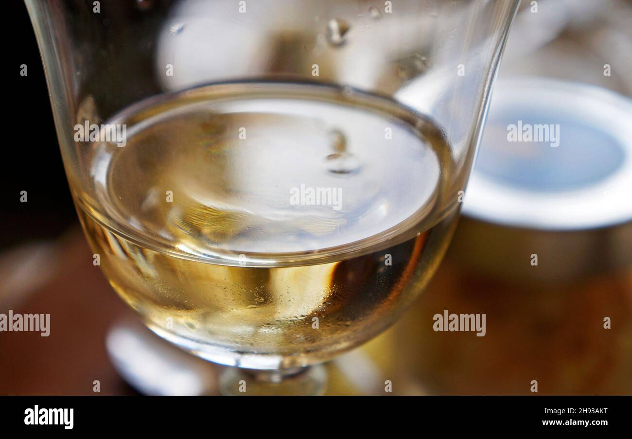 White wine glass on table (detail) Stock Photo