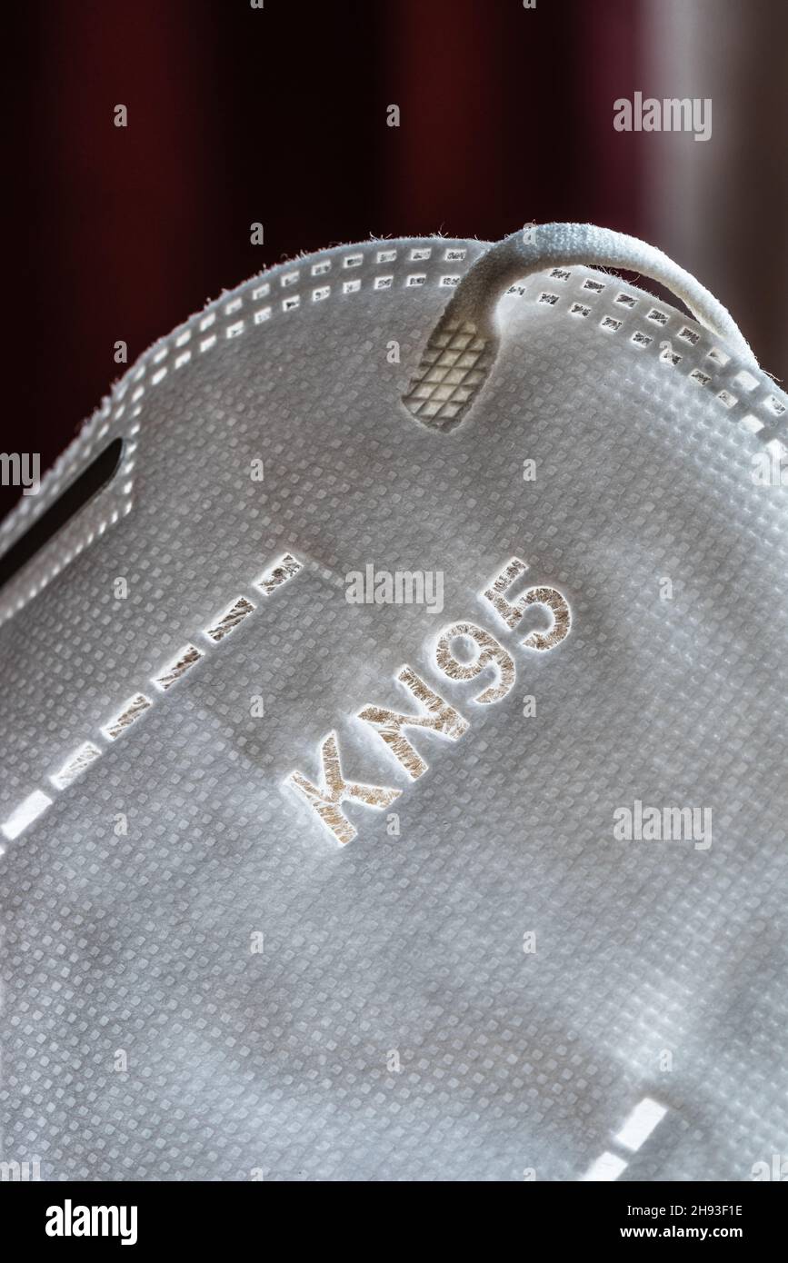 Close up of a white KN95 / FFP2 mask used to protect from Covid-19 Stock Photo