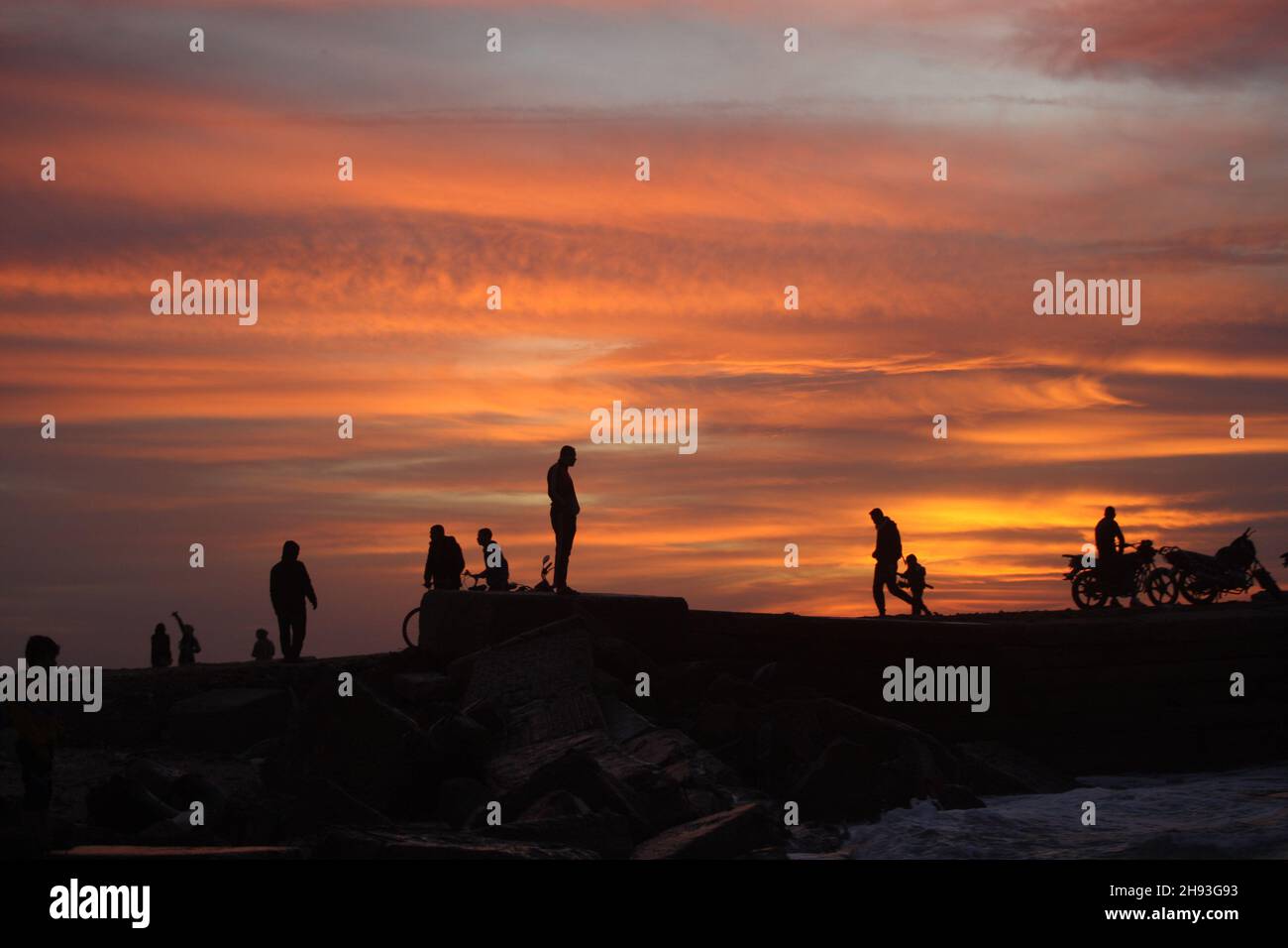 Rafah, Gaza. 03rd Dec, 2021. Palestinians and fishermen stand on a beach at sunset in Rafah, in the southern Gaza Strip, on on Friday, December 3, 2021. Photo by Ismael Mohamad/UPI Credit: UPI/Alamy Live News Stock Photo