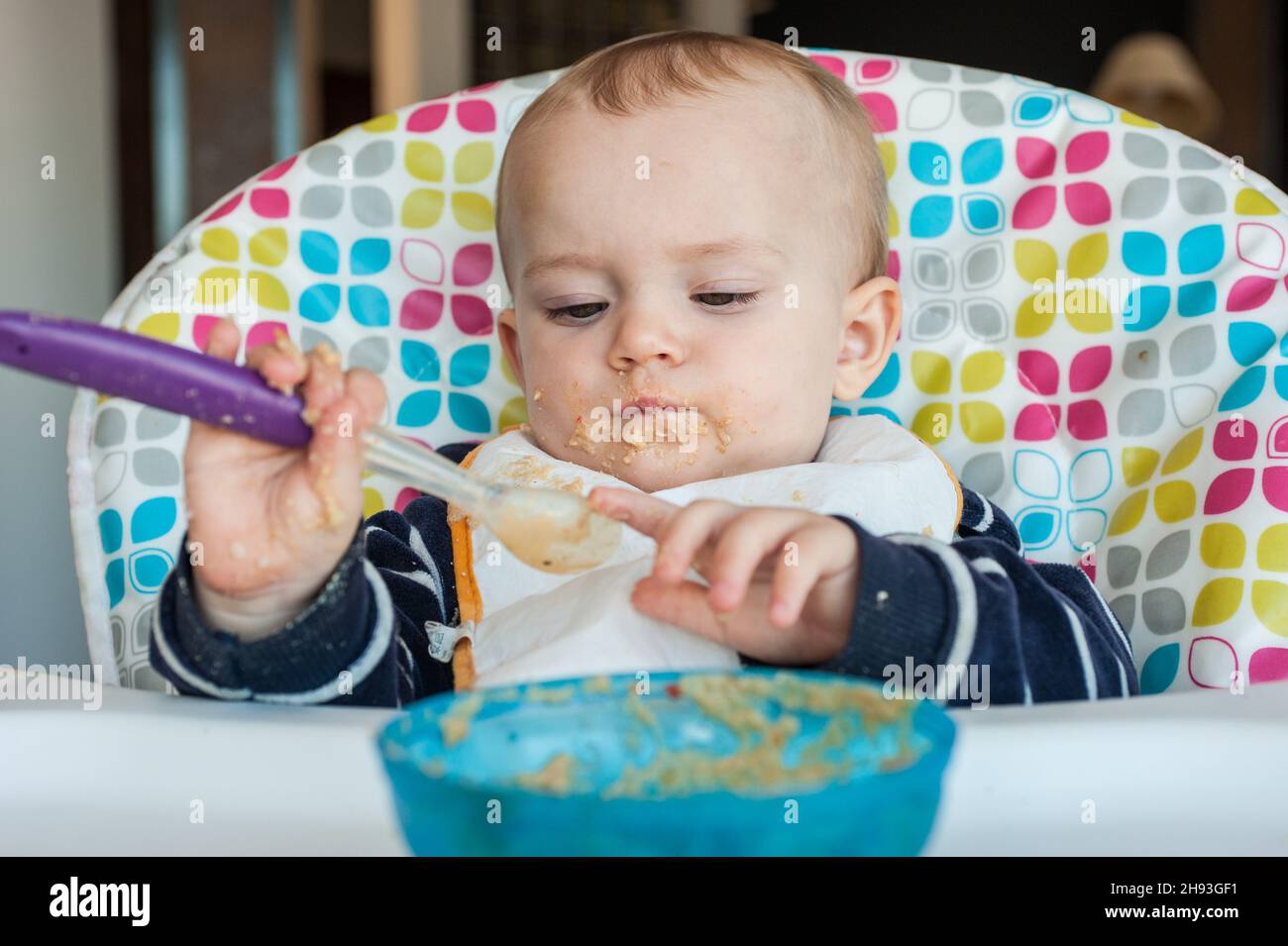 Infant Using Spoon Child learning to eat with spoon hi-res stock photography and images ...